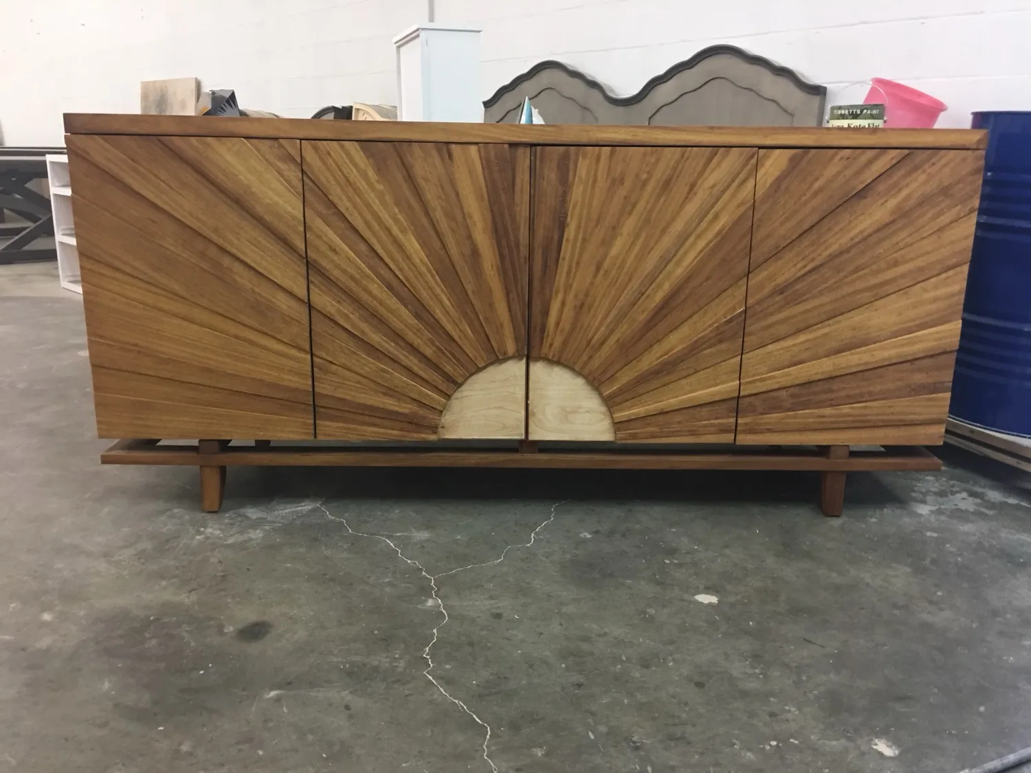 A walnut credenza with a hand-laid sunburst grain, finished in the shop